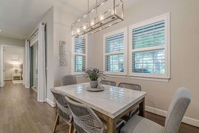 Dining area with baseboards, a chandelier, and wood finished floors | Image 18