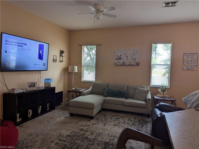 Living area featuring ceiling fan and carpet floors | Image 22