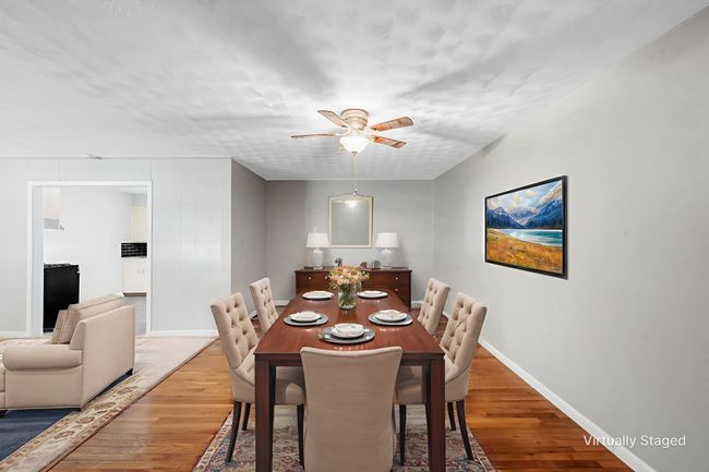 Dining area with wood finished floors and a ceiling fan | Image 4