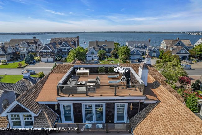 This roof top space has been virtually staged with furniture and bar. | Image 92