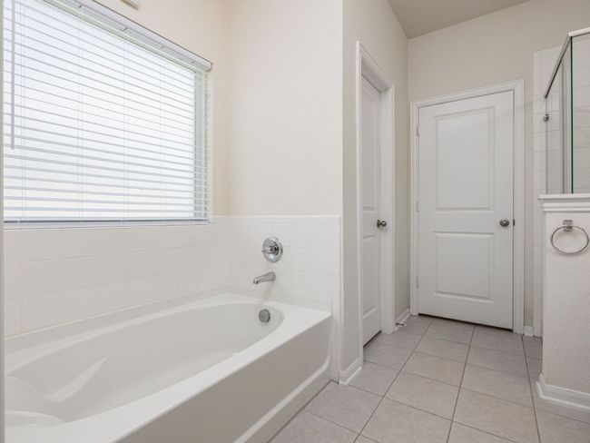 Primary ensuite featuring a garden tub, baseboards, and a shower | Image 14