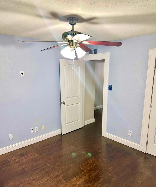 secondary oom with a ceiling fan, wood finished floors, and a textured ceiling | Image 31