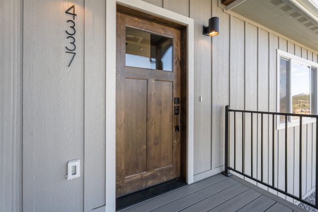 Property entrance featuring a balcony and board and batten siding | Image 6