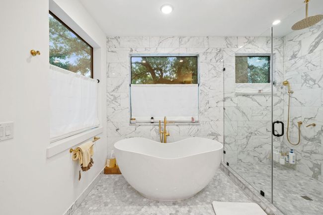 Full bath with plenty of natural light, a marble finish shower, a freestanding bath, and recessed lighting | Image 26
