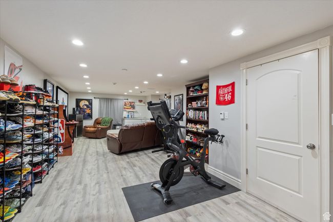 Workout area featuring LVP flooring and recessed lighting | Image 24