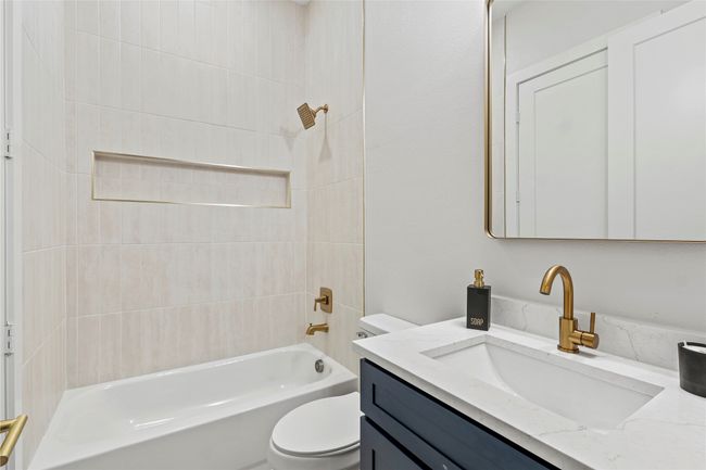 Bathroom featuring vanity and shower / bath combination | Image 22