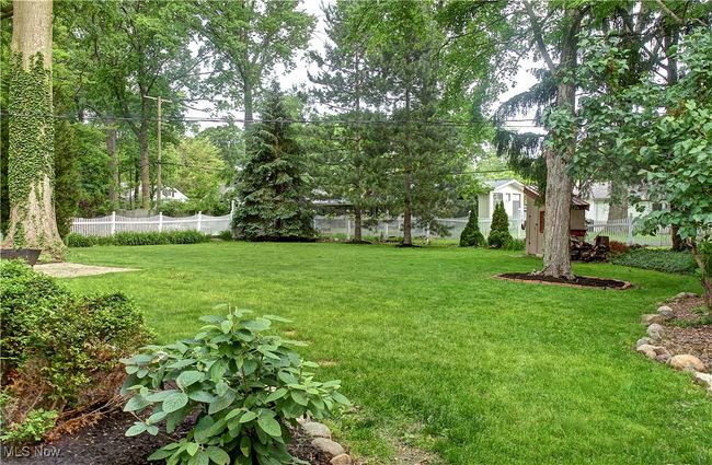 Fenced backyard with a storage shed | Image 36