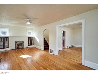 Living Room with decorative fireplace, hardwood floors and ceiling fan | Image 2