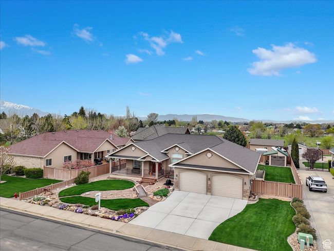 View of front facade with fence, a porch, stucco siding, and a garage | Image 38