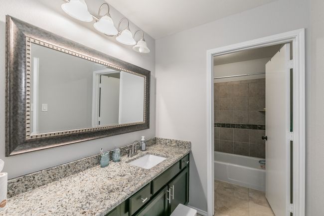 Unit 4904 Second Bathroom featuring vanity and tiled shower / bath | Image 37