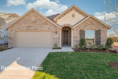 View of front of house featuring a garage and a front lawn | Image 1