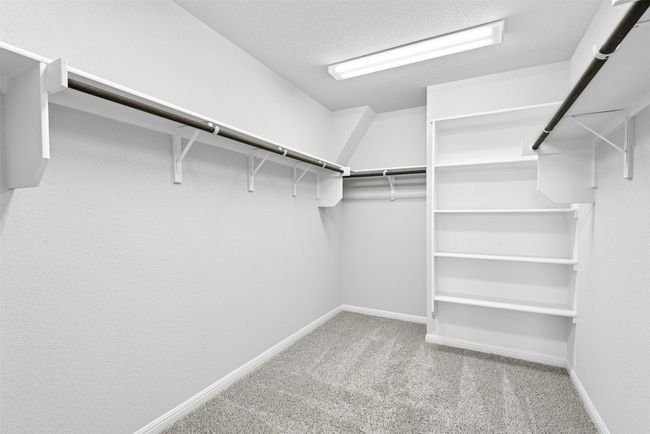 Spacious closet with carpet floors | Image 30