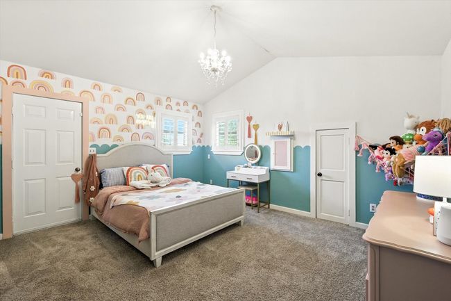 Bedroom featuring lofted ceiling, carpet, and a chandelier | Image 27