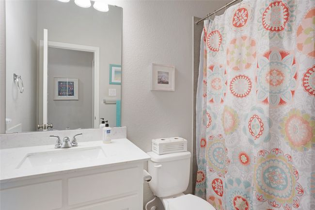 Full bathroom featuring vanity, a textured wall, and a shower with curtain | Image 13