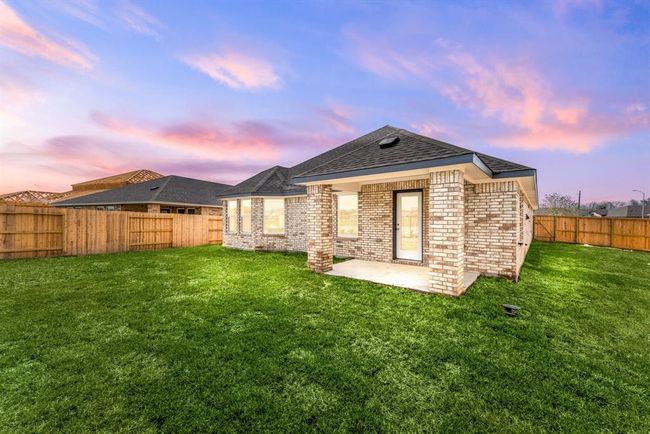 Sit back, relax and enjoy your gorgeous backyard overlooking the lake under your large covered patio. Complete with plenty of space for an outdoor kitchen or grilling station and outdoor seating. Your covered patio overlooks your huge backyard with plenty of green space for the kids and your furry friends to enjoy. | Image 18