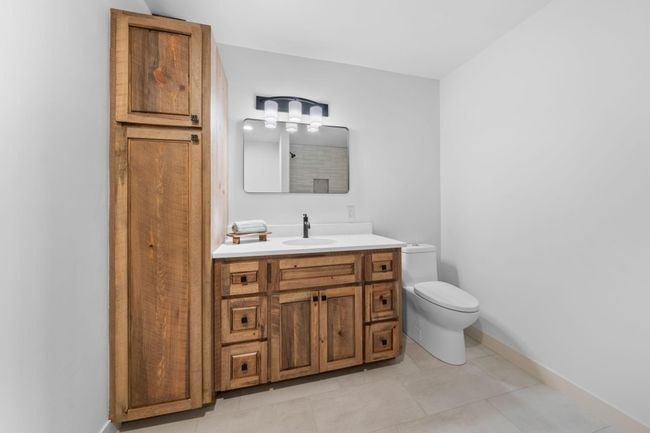 Lower level 3/4 bath. Newly constructed with in-floor heat and walk-in tile shower. | Image 34