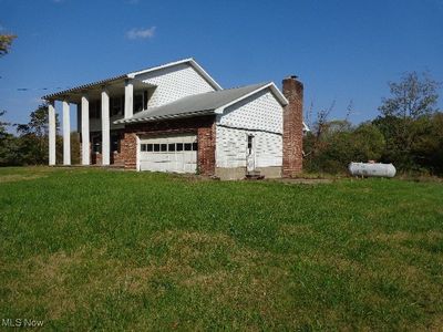 View of side of property with a yard and a garage | Image 2