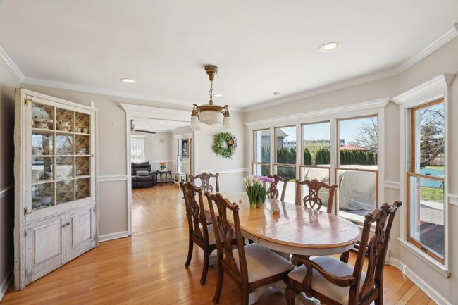 Dining room featuring crown molding, light wood-type flooring, and recessed lighting | Image 11