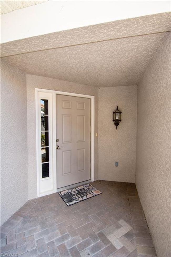 Private entry with a classic brick paved walkway. | Image 6