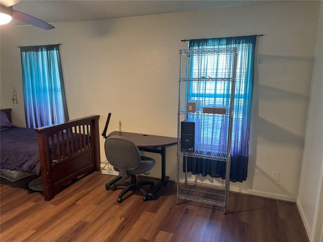 Bedroom featuring hardwood / wood-style flooring and ceiling fan | Image 16