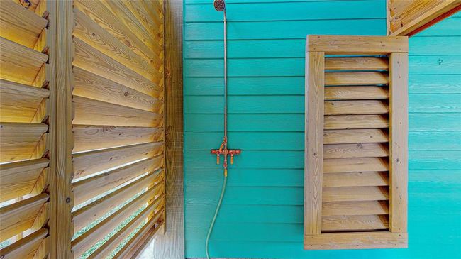 This beach house features a convenient outdoor shower, completed with hot water, perfect for rinsing off sand and salt after a day at the beach. It offers privacy, comfort, and a refreshing way to enjoy the coastal atmosphere. | Image 7