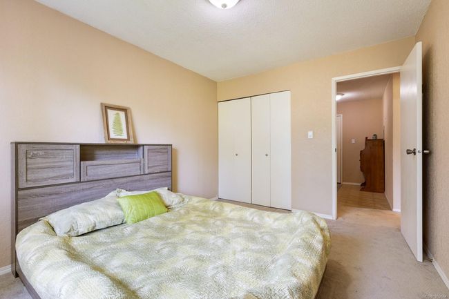 Bedroom with carpet flooring, a closet, and baseboards | Image 16
