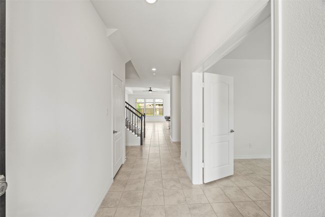 Corridor featuring stairway, light tile patterned floors, recessed lighting, and baseboards | Image 14