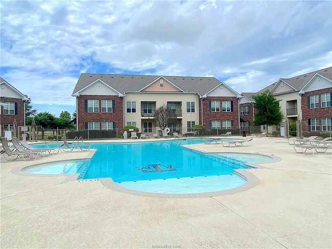 Community pool with fence and a patio area | Image 13