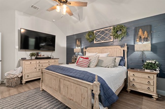 Primary bedroom featuring dark wood-style flooring, lofted ceiling, and a ceiling fan | Image 18