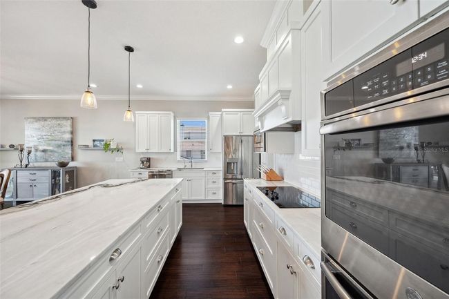 Kitchen boasts double ovens a new GE cooktop oversized center island, and reverse osmosis water filtration system. | Image 30