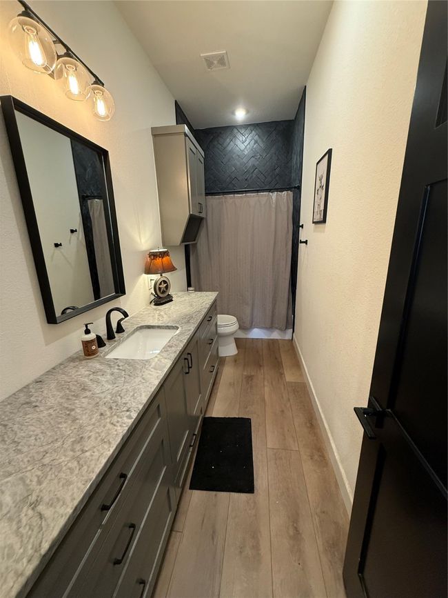 Bathroom featuring hardwood / wood-style floors, vanity, and curtained shower | Image 31