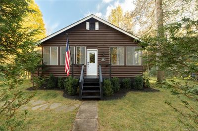 Log-style house featuring a front yard | Image 1