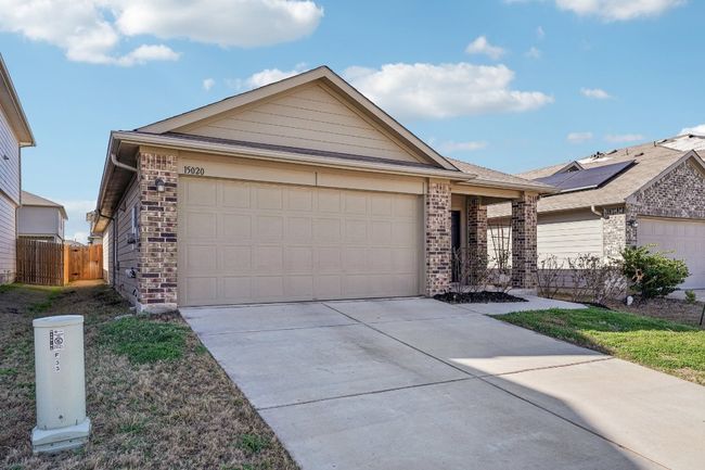 Ranch-style home featuring an attached garage, fence, brick siding, and driveway | Image 25