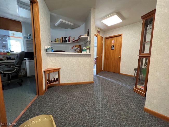 Hall with dark colored carpet | Image 7