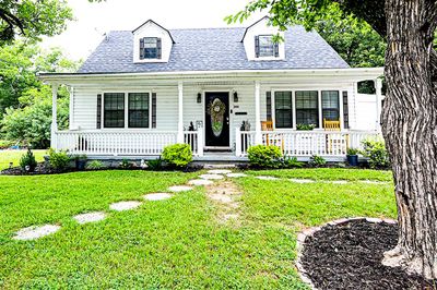 New england style home with a front yard and a porch | Image 2