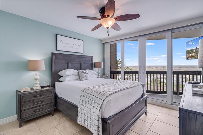 Guest bedroom with pool and bay views. | Image 17