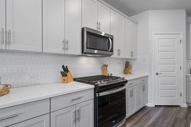 QUARTZ COUNTER TOPS, STOVE, AND MICROWAVE. | Image 4