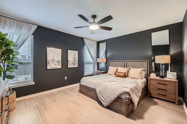 Bedroom featuring light wood-style flooring, multiple windows, baseboards, and ceiling fan | Image 14