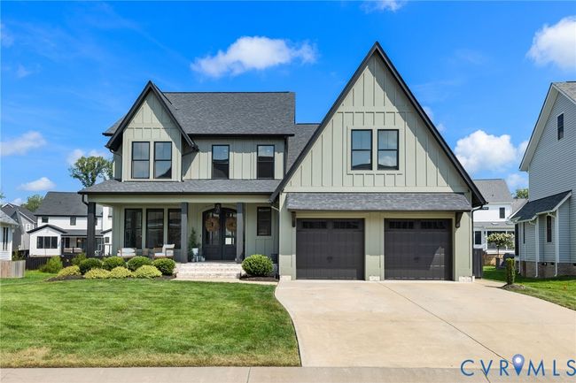 View of front of house featuring covered porch, board and batten siding, and a shingled roof | Image 9