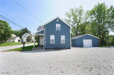 View of front facade with an outdoor structure and a garage | Image 2