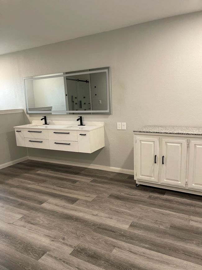 Bathroom featuring vanity and hardwood / wood-style flooring | Image 9