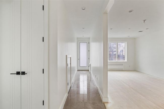 Corridor with radiator and baseboards | Image 5