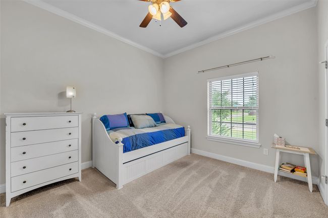 Bedroom featuring crown molding, carpet, baseboards, and a ceiling fan | Image 29