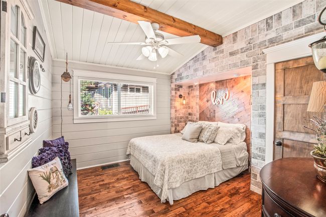 Bedroom 2 with ship lab walls and hand scraped wood floors | Image 10