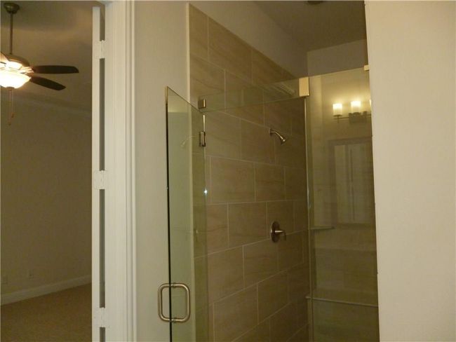 Bathroom featuring ceiling fan and a shower stall | Image 7