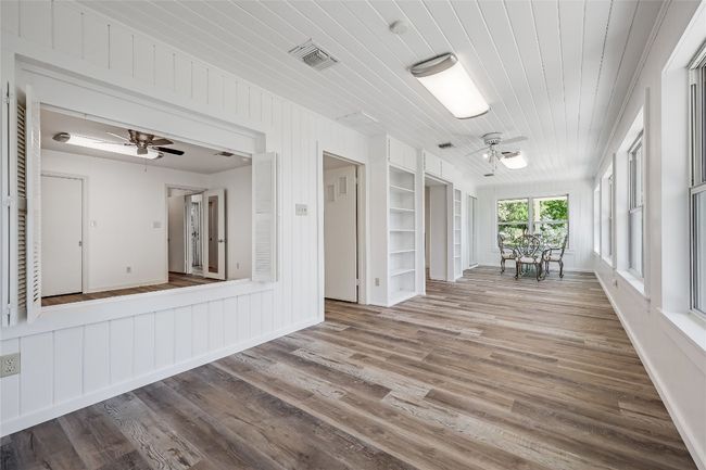 The second access to the Primary Bedroom is off the additional/bonus room, and captured here through the oversized, shutter framed window | Image 6