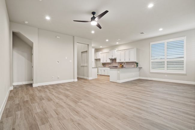 Unfurnished living room with ceiling fan, light wood-style floors, and recessed lighting | Image 6