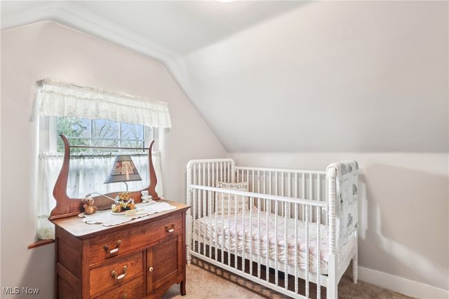 Bedroom with lofted ceiling and carpet | Image 21