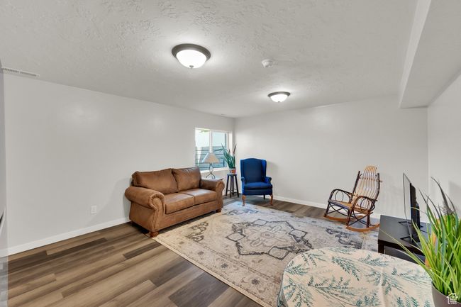 Living room with wood finished floors and a textured ceiling | Image 28