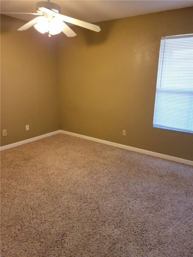 Spare room with ceiling fan and carpet | Image 5